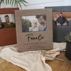May include: Three personalized photo albums in brown, tan, and gray. The tan album has the word "Funcle" and the text "Like a dad, only cooler" printed on it. Each album has a rectangular photo window.