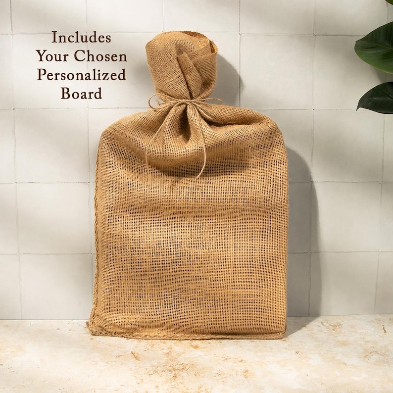 A burlap sack tied with a string, placed on a white tiled surface against a white wall.