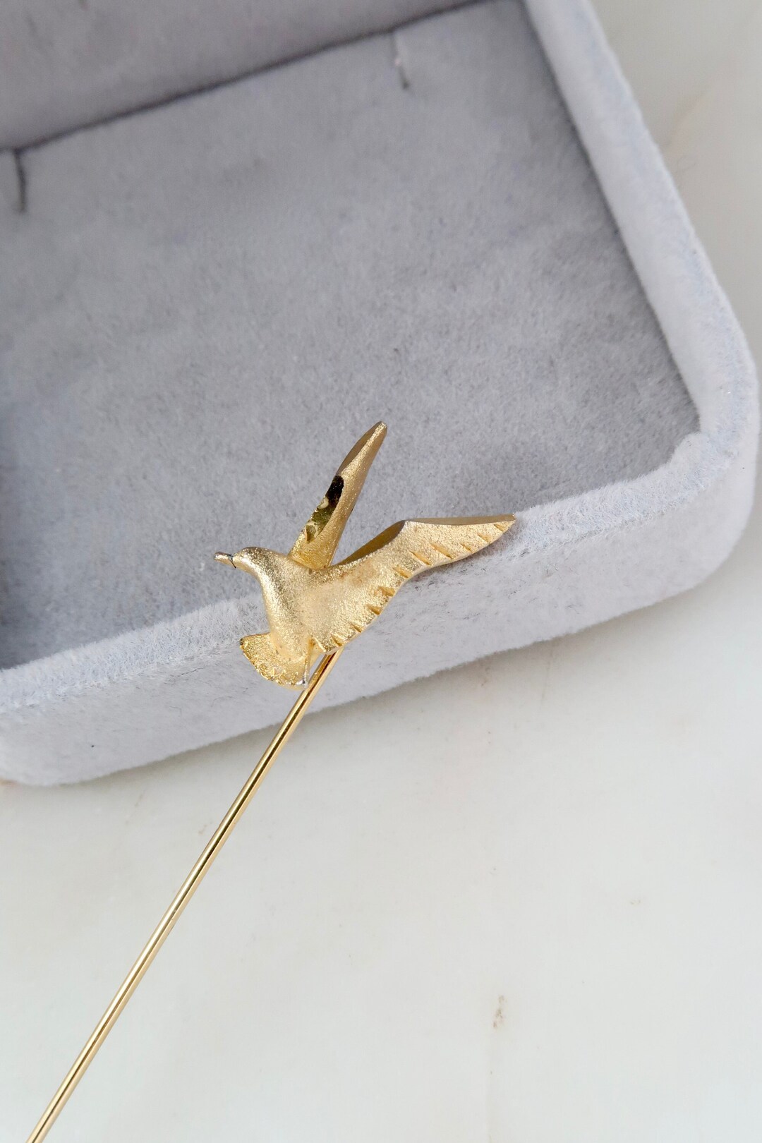 Gold bird pin discount