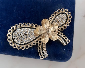 Vintage svart emaljbrosch med strass och rosett