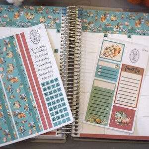 May include: A set of planner stickers with a fall theme. The stickers feature a variety of designs, including pumpkins, gourds, and leaves. The stickers are in shades of orange, brown, and green. The stickers are designed to be used in a planner or journal.