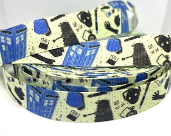 May include: A roll of yellow and blue patterned ribbon with a Doctor Who theme. The ribbon features images of the TARDIS, a Dalek, and the words "Wibbly Wobbly Timey Wimey".