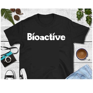 May include: Black t-shirt with the word "Bioactive" printed in white. The word is surrounded by small white images of insects.