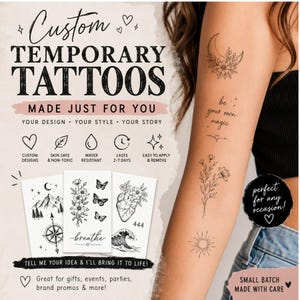 May include: Custom temporary tattoos featuring black ink designs including a crescent moon with flowers, the text be your own magic, floral stems, and a sun. The sheet displays various illustrations like mountains, a compass, butterflies, and a heart.