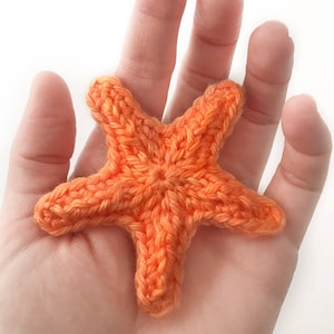 May include: A crocheted orange starfish, a popular beach-themed craft project.