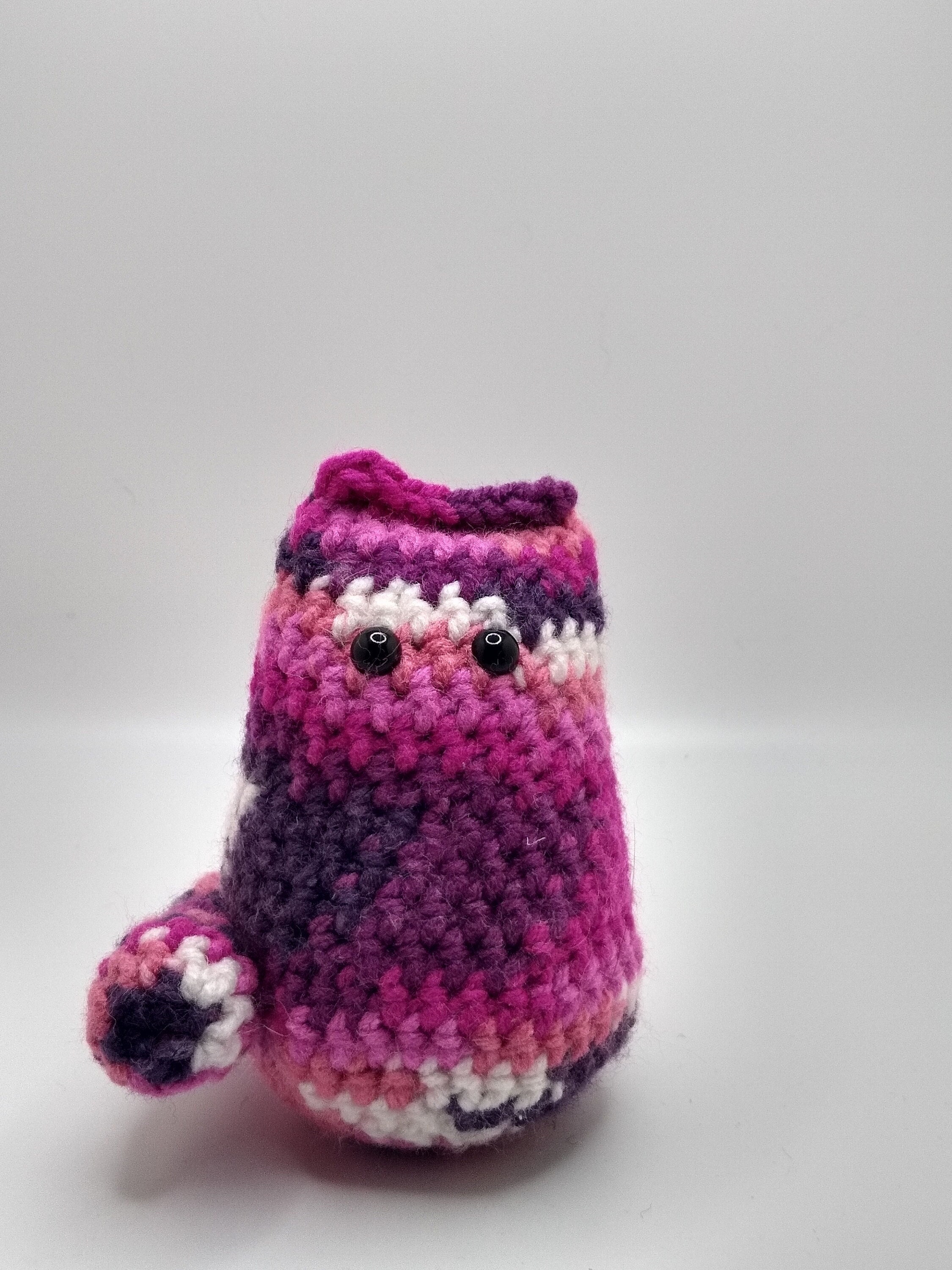 small berry colored amigurumi cat plushy desk buddy