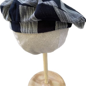 Black and white striped hat with accents of salmon-colored canvas. One-of-a-kind.