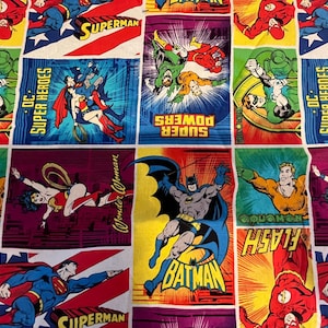 May include: Fabric featuring comic book panels with DC Superheroes. Superman, Batman, Wonder Woman, and Flash are depicted in action poses. The fabric has a colorful, vintage aesthetic with bold lines and vibrant colors.