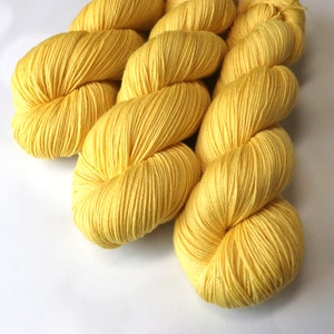 Hand Dyed KM Fingering Sock Yarn Superwash Merino Wool Nylon in a sunny Taxi Cab Yellow