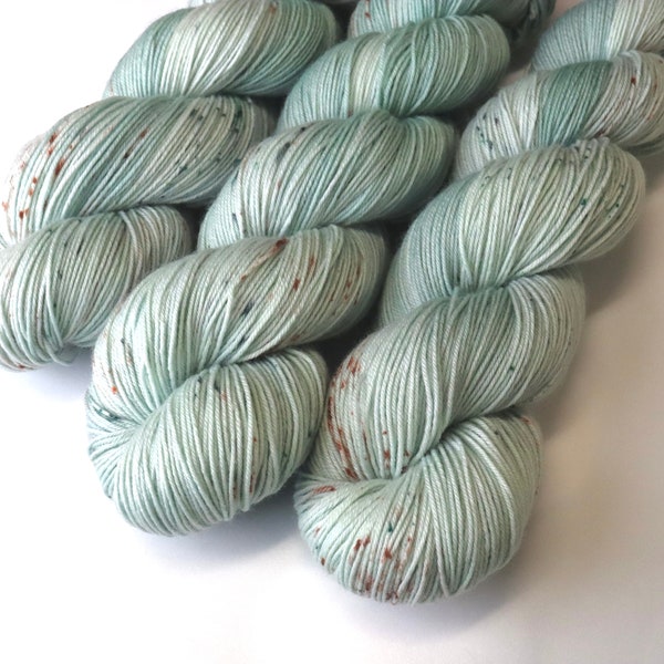 Hand Dyed KM Fingering Sock Yarn Superwash Merino Wool Nylon in Pale Green with Brown and Green Speckles