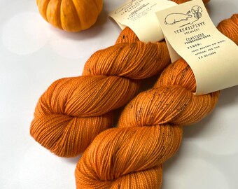 Coastside Sock Merino Hand Dyed Yarn in Pumpkin Orange with Gray Speckles