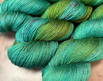 Hand Dyed Silk BFL Wool Fingering Yarn in Shaded of Green and Teal with Burgundy Speckles