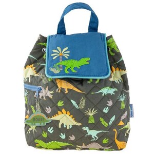 May include: A dinosaur-themed quilted backpack. It has a blue flap with a green dinosaur and palm tree embroidery. The main body is dark grey with a repeating dinosaur pattern. A small tag reads "ROAR!"