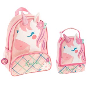 May include: Pink unicorn backpack and lunch bag set with a plaid pattern and the name "Kaia" on the front.