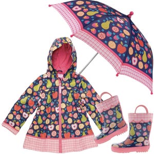 May include: A navy blue hooded raincoat, a pair of matching rain boots, and an umbrella, all featuring a colorful pattern of apples, pears, strawberries, and citrus slices, with pink plaid trim and pink accents on the boots and umbrella.