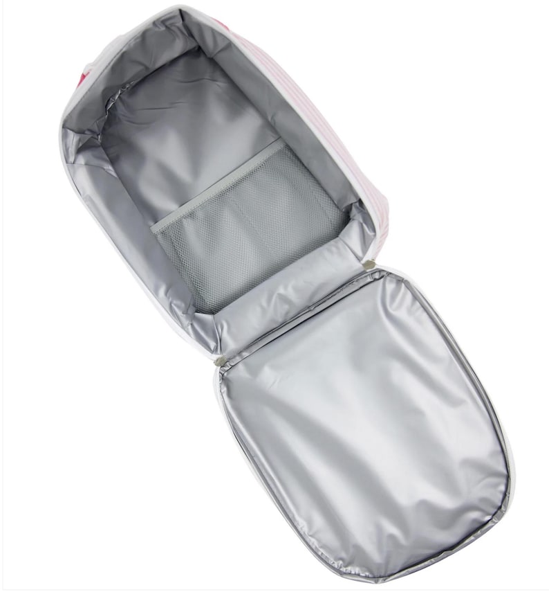 May include: Open, insulated lunch bag with a white and pink striped exterior. The interior features a silver lining, a mesh pocket, and a zippered closure. The bag is designed to keep food and drinks cool.