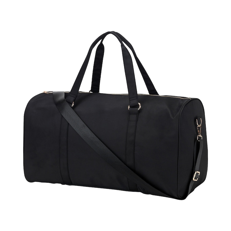 May include: A black duffel bag with a long shoulder strap and two top handles. The bag has gold-colored hardware.