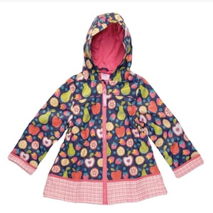 May include: A navy blue hooded raincoat featuring a colorful all-over print of red apples, green pears, strawberries, and citrus slices. The jacket includes a bright pink interior lining, a front zipper closure, and a light pink plaid hem and cuffs.
