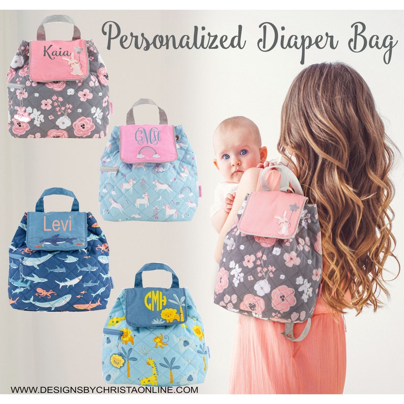 May include: Personalised diaper bags in various designs. The bags feature quilted fabric with floral, unicorn, shark, and jungle animal patterns. Each bag has a top handle and a front flap with a name or initials. The bags are shown in a variety of colours.