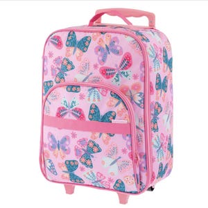 May include: A pink rolling suitcase featuring a repeating pattern of colorful butterflies in shades of blue, orange, and white. The luggage includes a top handle, a front zippered pocket with a horizontal pink strap, and small wheels at the base.