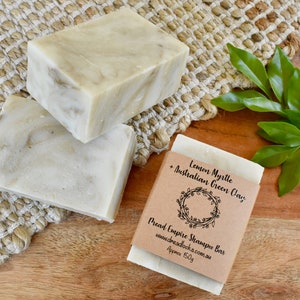 May include: Two bars of green and white soap with a brown paper label that reads "Lemon Myrtle + Australian Green Clay Dread Empire Shampoo Bar www.dreadlocks.com.au Approx 150g"