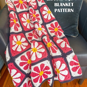 May include: A crochet blanket featuring a repeating granny square pattern with daisy motifs in white, pink, and yellow, bordered in dark gray. The text DAISY GRANNY SQUARE BLANKET PATTERN and PDF INSTANT DOWNLOAD are printed on the image.