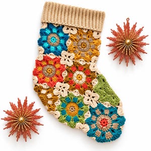 May include: A crochet Christmas stocking constructed from multi-coloured floral granny squares in shades of blue, red, green, and gold, featuring a tan ribbed cuff. Two starburst-shaped ornaments with metallic red spikes flank the stocking.