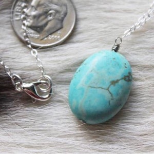 Brilliant blue turquoise stone with sterling silver or 14 karat gold filled chain.