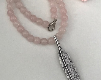 Rose quartz necklace, and silver metal feather