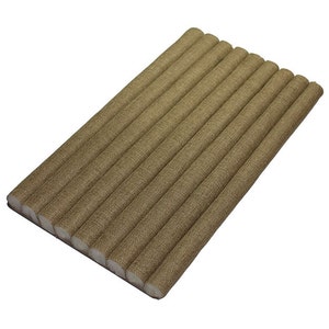 May include: A rectangular arrangement of ten cylindrical, tan-colored objects. Each cylinder has a textured, woven appearance. The ends are white. The objects are arranged in parallel rows, suggesting a mat or pad.