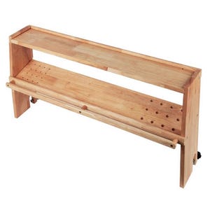 May include: A light-colored wooden kitchen cart with two shelves and a towel rack. The top shelf is a solid surface, while the lower shelf has several small holes. The cart has a simple, functional design and is suitable for kitchen storage.