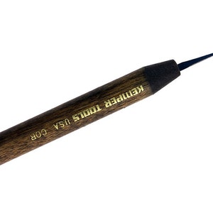 May include: A black and brown wood handled tool with a sharp, pointed tip. The handle is labeled "Kemper Tools USA COR".