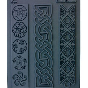 May include: A gray rubber stamp with three different border designs. The designs include a Celtic knot, a geometric pattern, and a floral pattern. The stamp is labeled "Ethnic Borders".