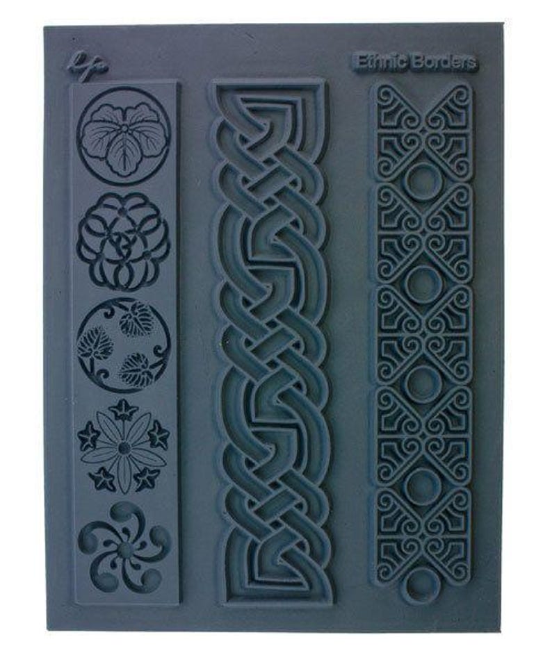 May include: A gray rubber stamp with three different border designs. The designs include a Celtic knot, a geometric pattern, and a floral pattern. The stamp is labeled "Ethnic Borders".