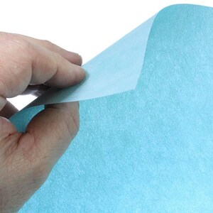 May include: A sheet of light blue tissue paper. The paper has a slightly textured surface.