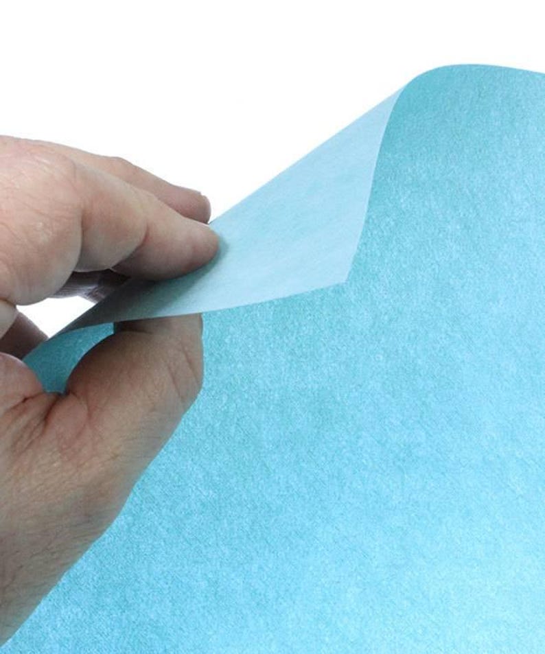 May include: A sheet of light blue tissue paper. The paper has a slightly textured surface.