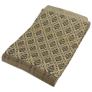 May include: A stack of brown paper bags with a black damask pattern. The bags are tied together with a rubber band.