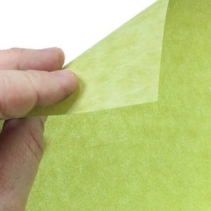 May include: A sheet of light green textured paper with a slightly lighter green color on the underside.