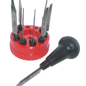May include: A set of engraving tools, including a red holder with multiple blades and a black-handled tool. The blades are labeled with text such as "HSS GRS QC-53" and "GMT HSS N-10". The tools are designed for detailed work.