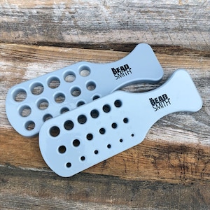 May include: Two gray plastic bead sizing tools with holes of different sizes. The tools are labeled "Bead Smith".