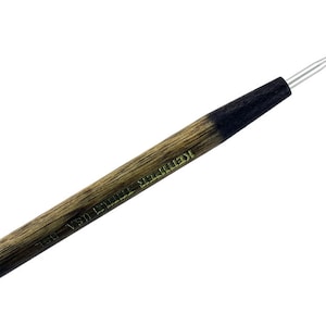 May include: A wooden tool with a metal ball on the end. The tool is labeled "16" "USA" "STEEL" "NEEDLE".