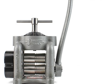 May include: A gray metal hand-cranked metal rolling mill with a black handle. The rolling mill has three sets of rollers and a black knob on the side. The text "PRECISION TOOLS" is visible on the front of the machine.