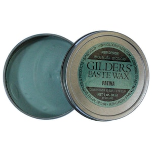 May include: A small tin of Gilders Paste Wax in the color Patina. The tin is silver with black lettering and a green lid. The text on the tin reads "Gilders Paste Wax Patina Covers over 30 sq ft - 2.78 sq m Net 1 oz - 30 ml by volume Made in USA - 28 Colors New Design www.gilderspaste.com Conforms to Art Materials ASTM D-4236 MFG by Products - 800-825-0029"