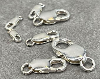 May include: Five silver-toned lobster clasps of varying sizes. The clasps are used for attaching jewelry chains or cords.