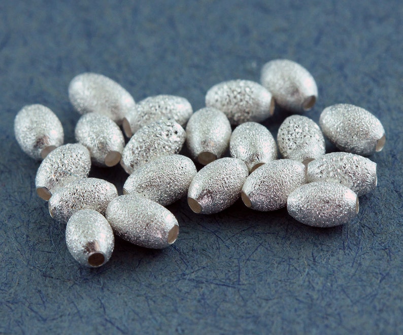 ABS-OSD1 Pkg of 20 Sterling Silver Oval Star Dust Beads 3x4.5mm