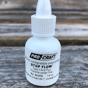 May include: A white bottle of Pro-Craft Stop Flow Type II Anti-Flux, a non-toxic, biodegradable prepared liquid that prevents solder flow. The bottle is labeled with the product name, type, and instructions. It is a 1/4 ounce bottle.
