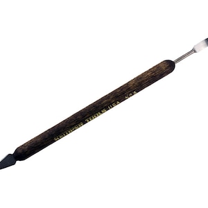 May include: A wooden handled tool with a pointed metal tip. The handle is brown and has the text "KEMPER TOOLS USA K25" printed in gold lettering.