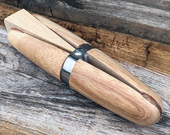 May include: A wooden ring mandrel with a metal band. The mandrel is used to size and shape rings.