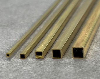 May include: Six pieces of brass square tubing of varying sizes. The tubing is gold in color and has a smooth, polished finish.