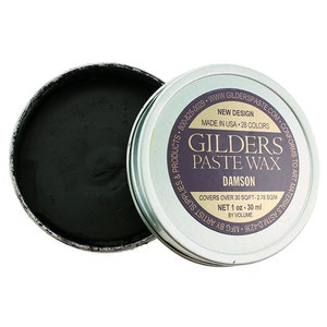 May include: A small, round tin of Gilder's Paste Wax in the color Damson. The tin is silver with black lettering and a purple label that says "Gilder's Paste Wax" and "Damson". The label also says "New Design, Made in USA, 28 Colors, Covers over 30 sq ft - 2.78 sq m, Net 1 oz - 30 ml by volume, Mfg by D.A.S.T.C. Artist Supplies & Products, 800-825-0029, www.gilderspaste.com, Conforms to Art Materials ASTM D-4236".
